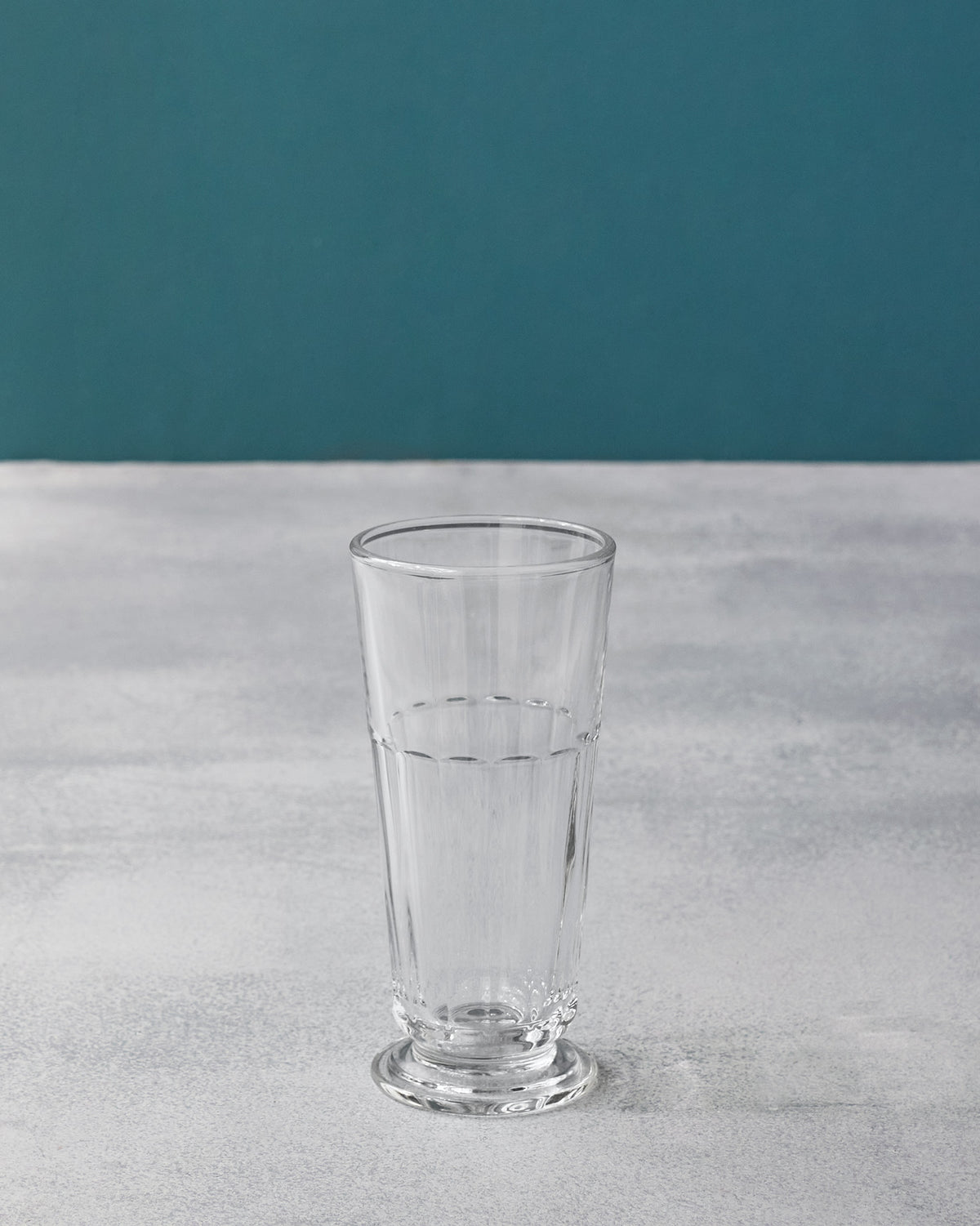 Tall clear Mahi beer glass with vertical fluting and a footed base.