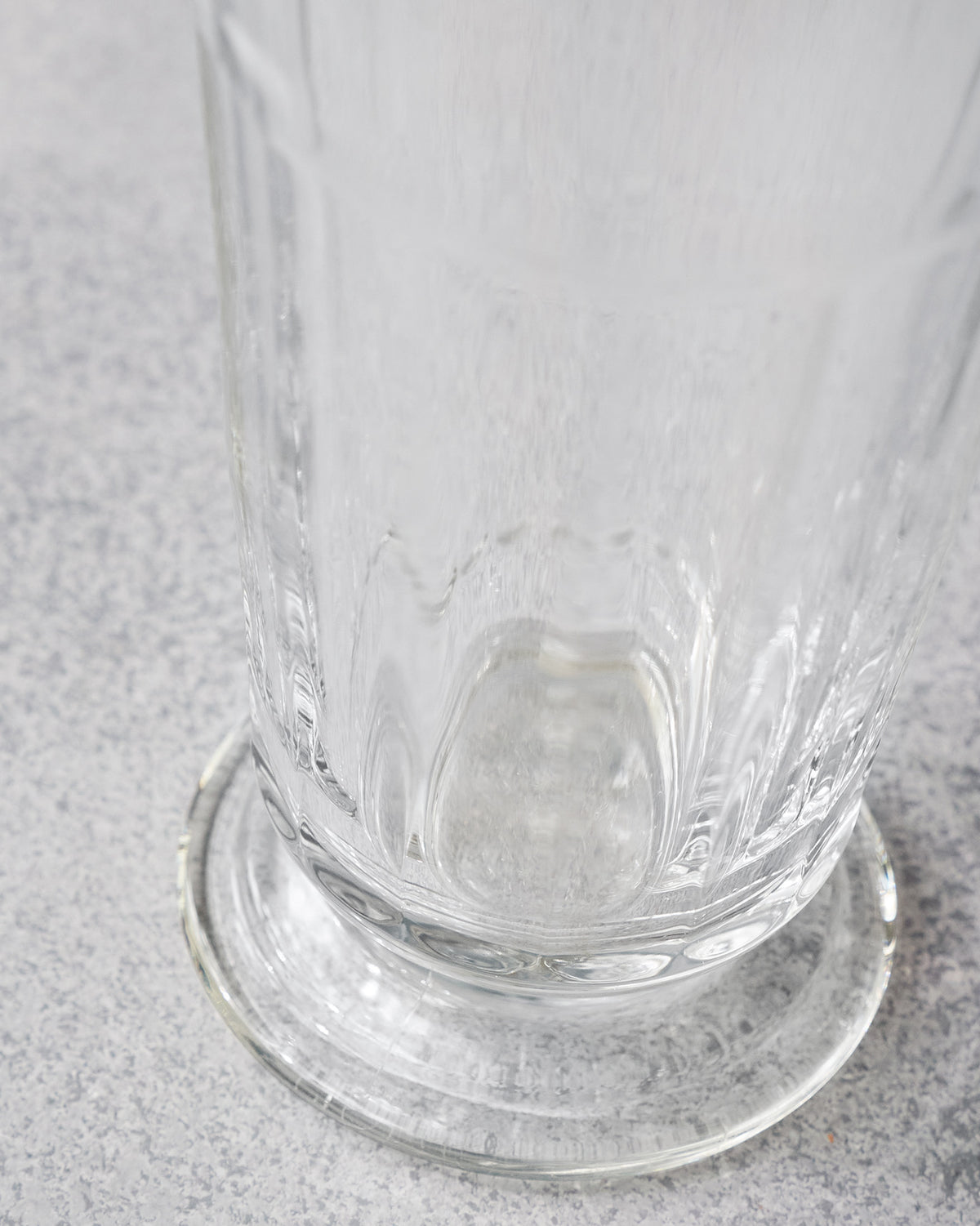 Close-up of the fluted base of a clear Mahi beer glass.
