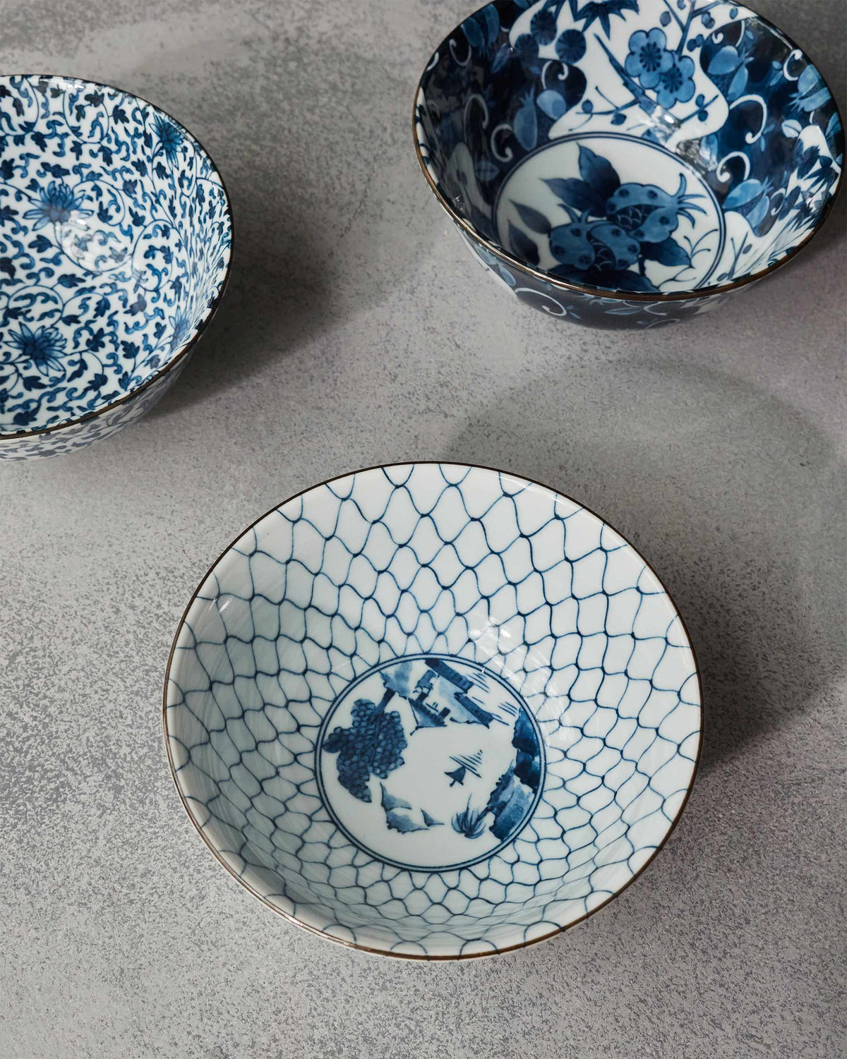 Blue and white Aiiro bowls showing lattice and botanical interior patterns.