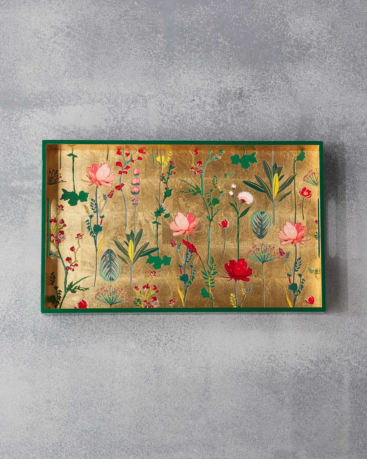 Mahi Rectangle Tray against a grey wall, showing its full floral print.
