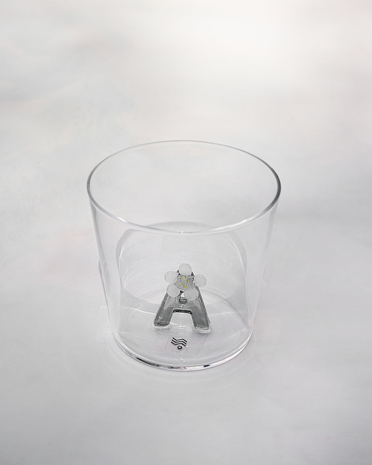 Clear tumbler with a 3D letter A topped by a white flower at the base.