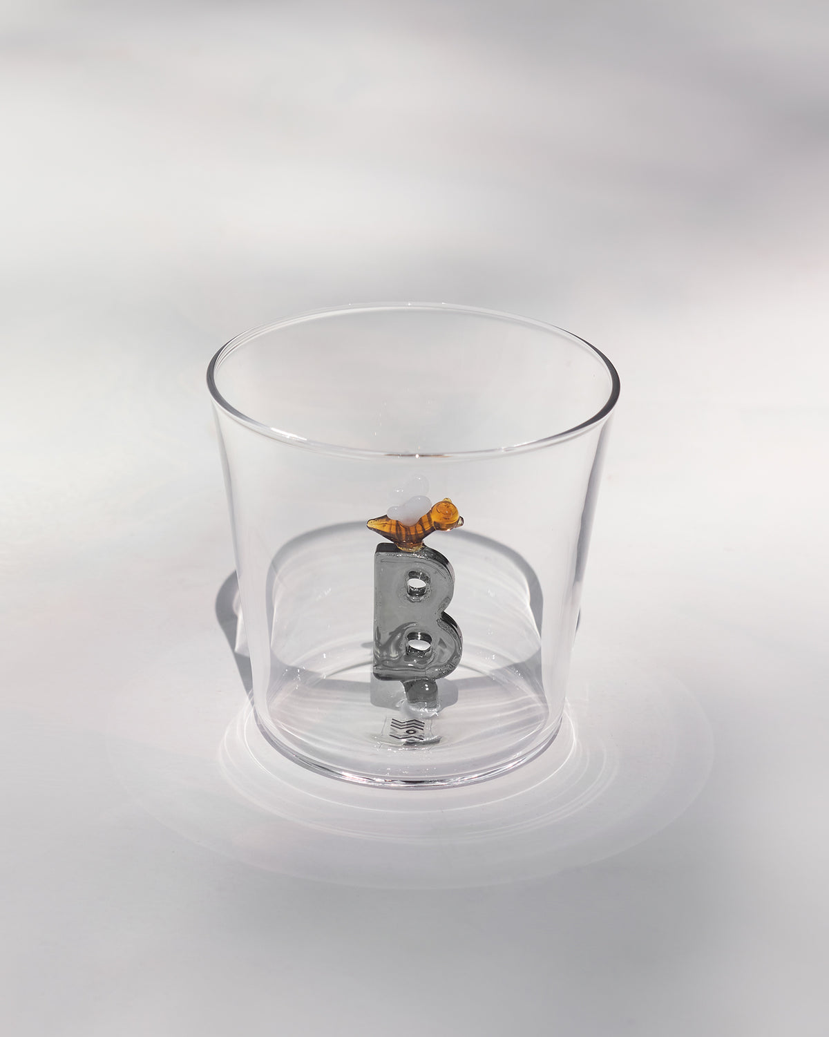 Clear tumbler with a 3D letter B topped by a tiny bee at the base.