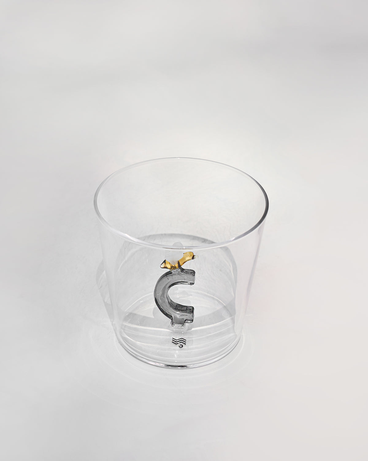 Clear tumbler with a 3D letter C topped by a tiny bee at the base.