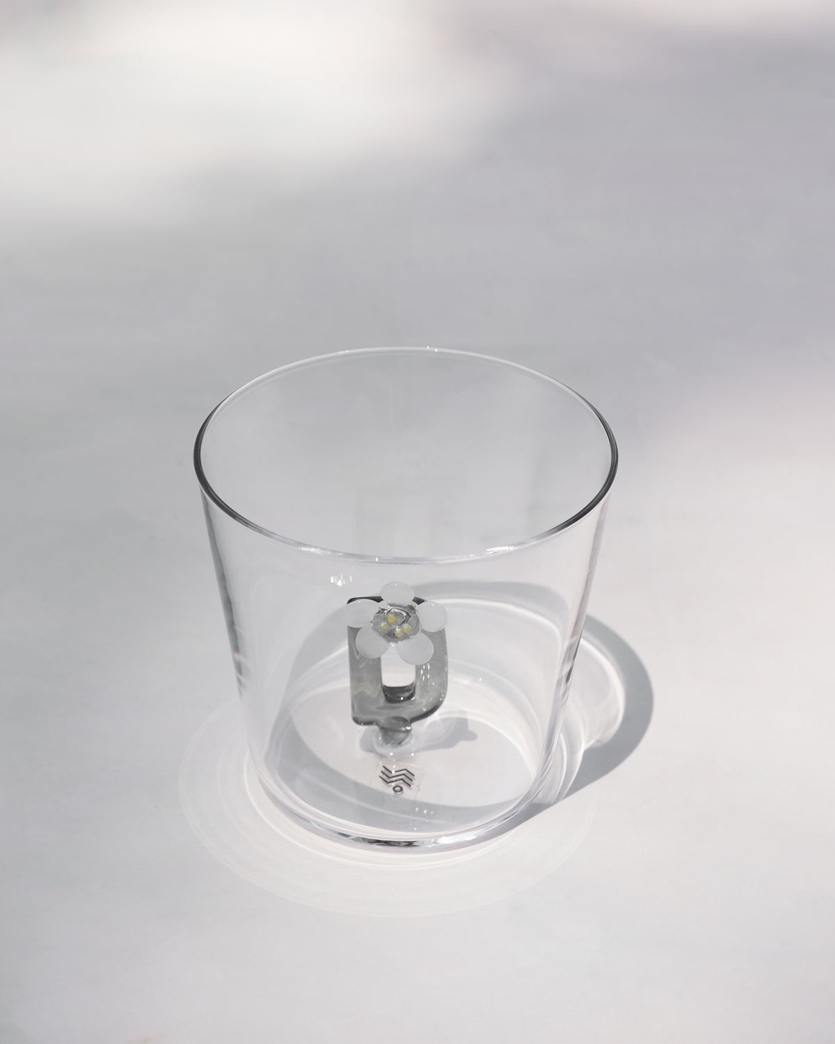 Clear tumbler with a 3D letter D topped by a white flower at the base.