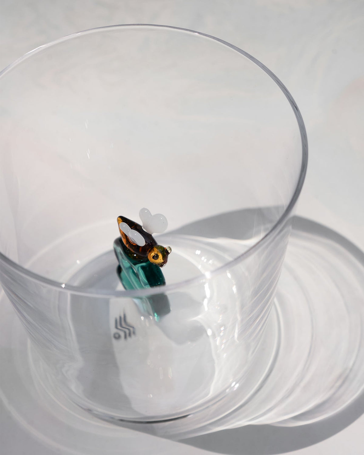 Looking into an Alphabet S glass showing a bee detail.
