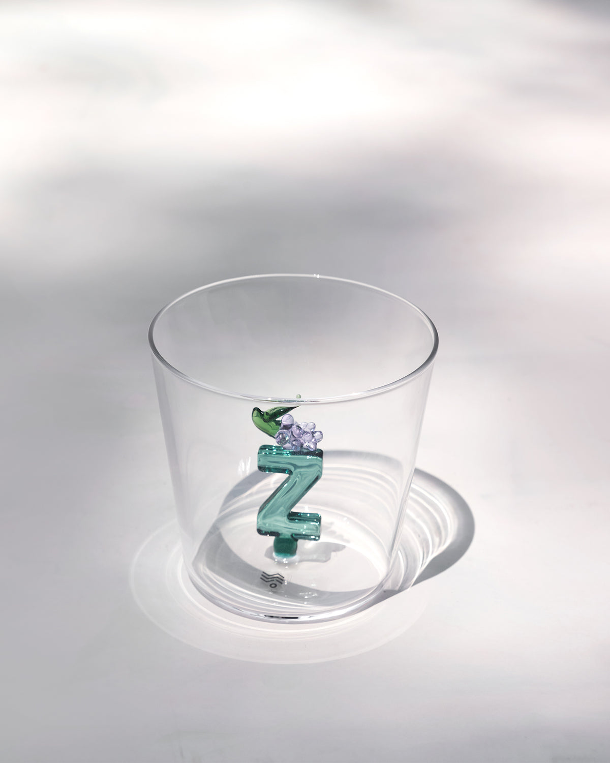 Clear Alphabet glass showing a teal letter Z with purple grapes at the base.