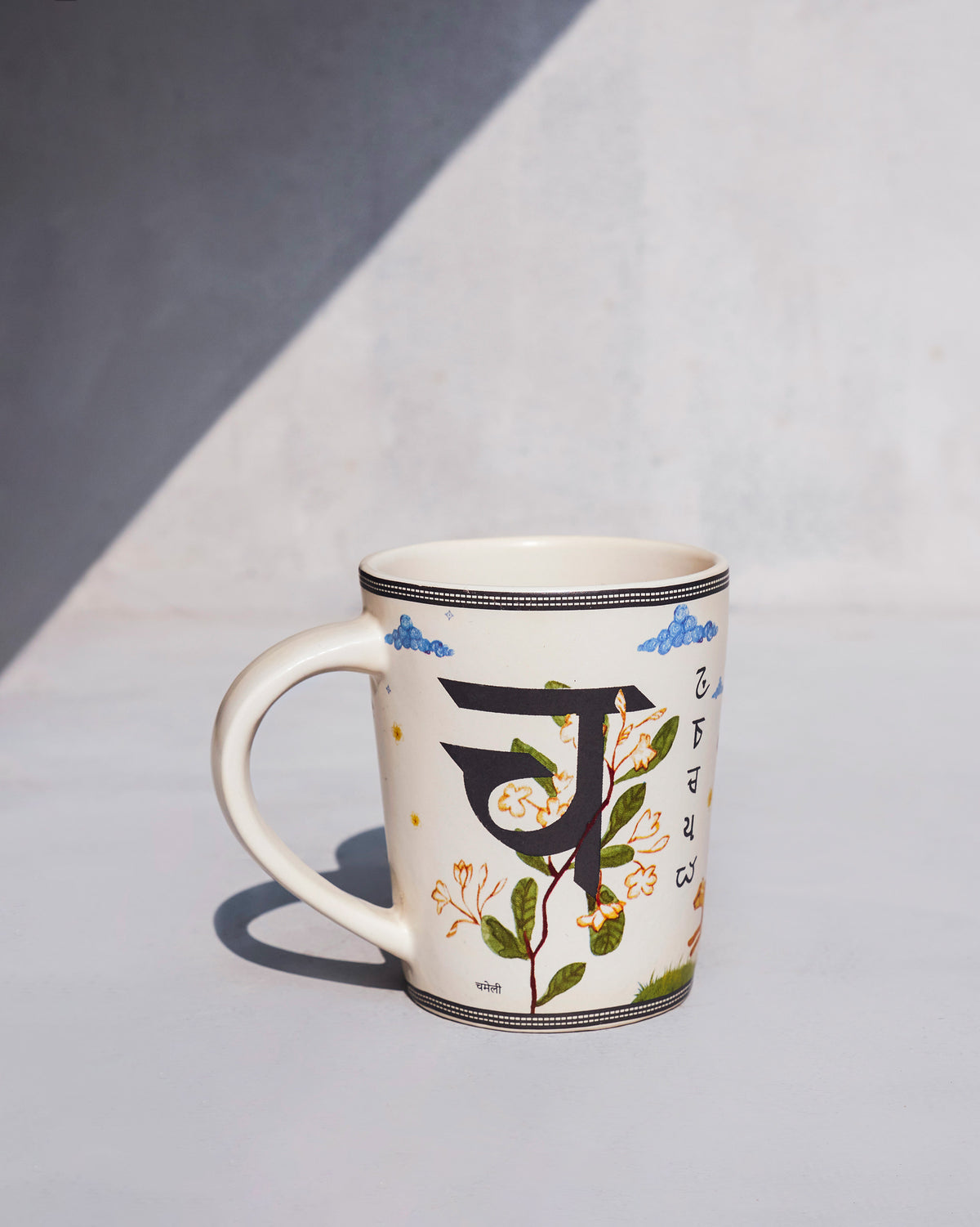 Chameli mug with Devanagari cha and a white jasmine vine print.