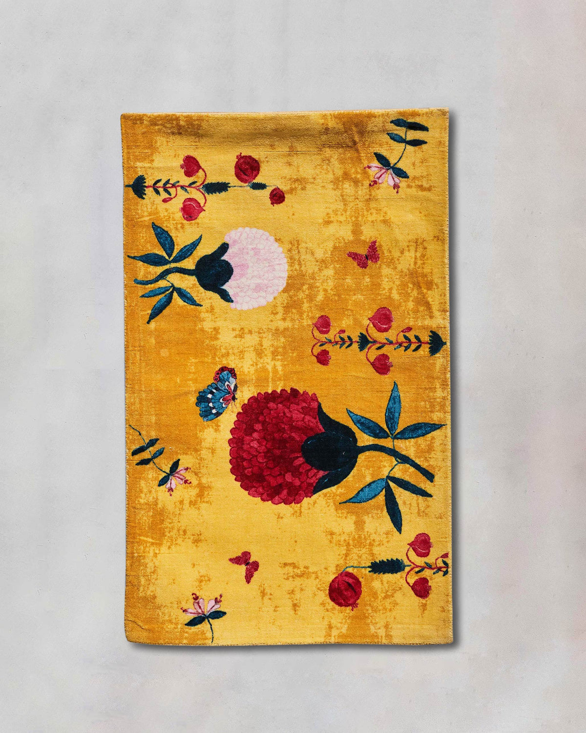 Woodland Rug in yellow with red, pink and teal flower motifs.