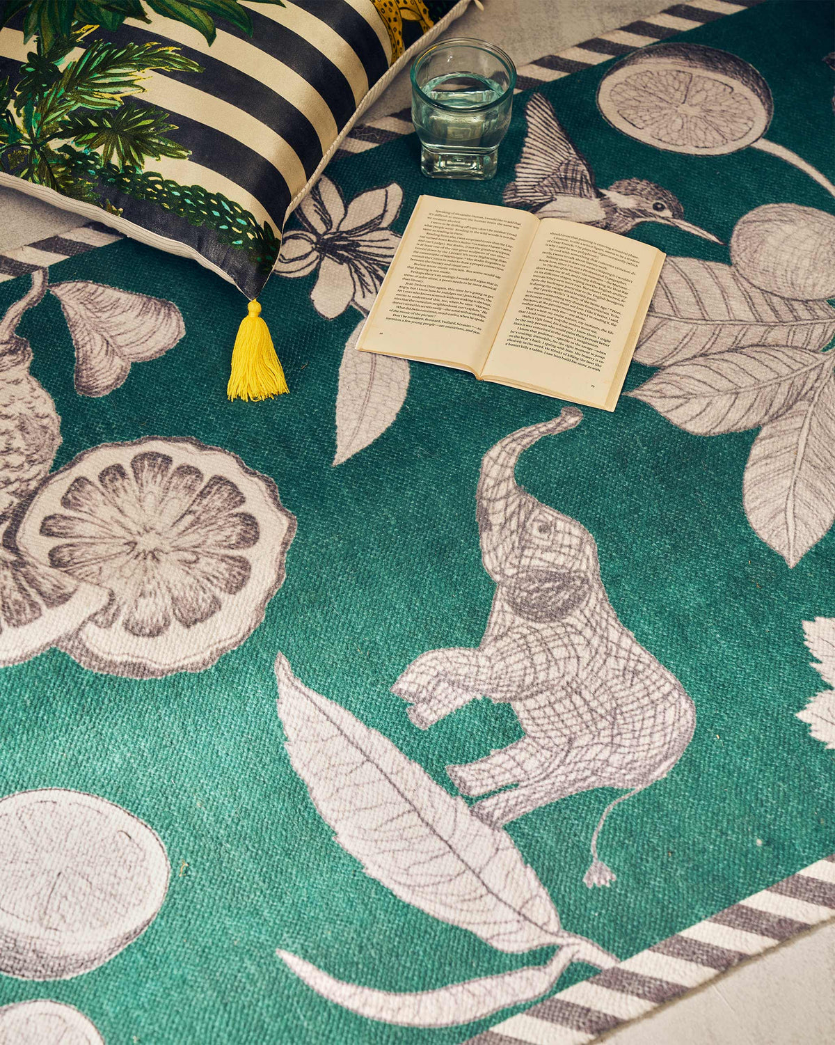 Close-up of Zaka Rug showing elephant, citrus and hummingbird motifs.