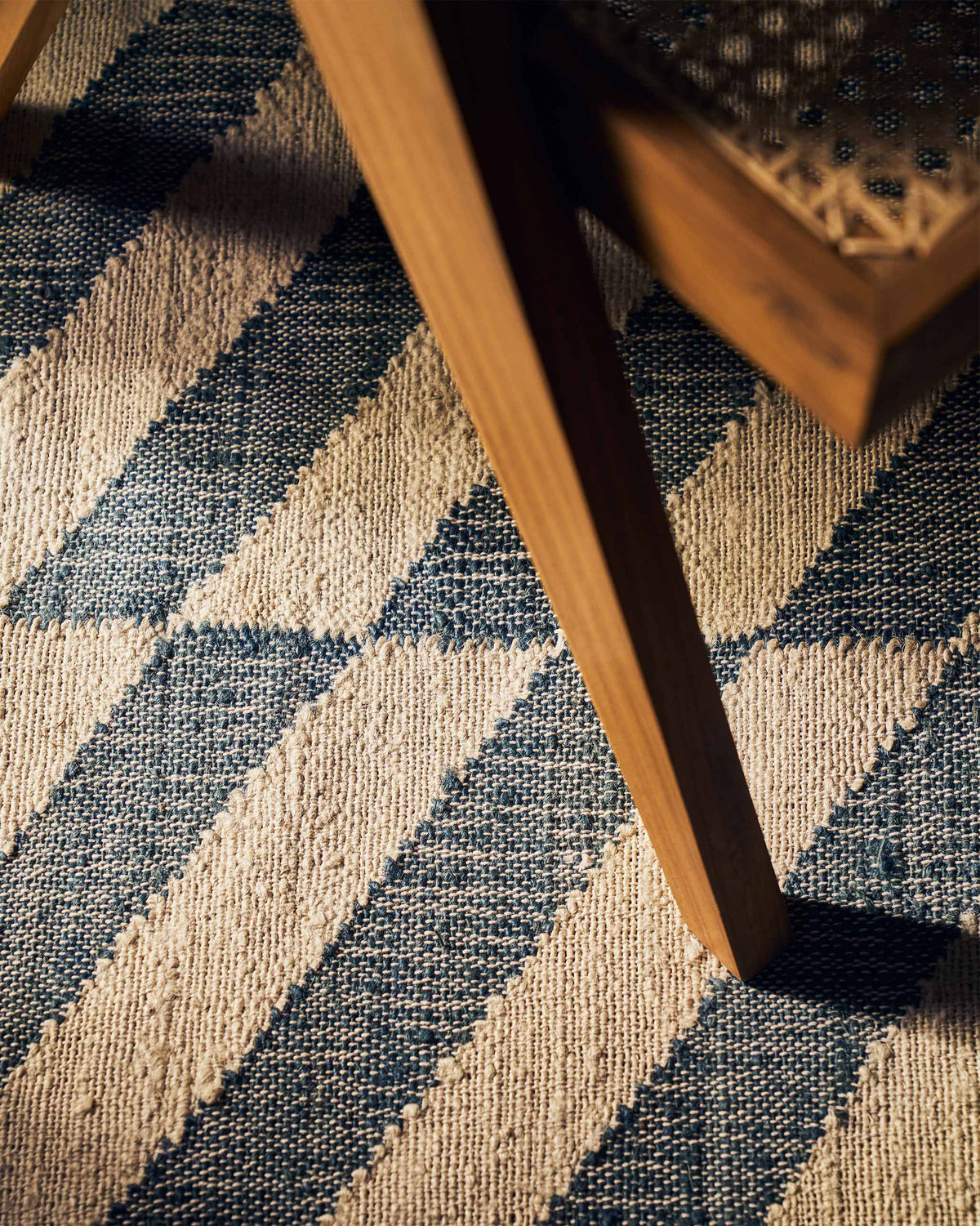 Close-up of Nico Rug showing its blue and cream woven texture.