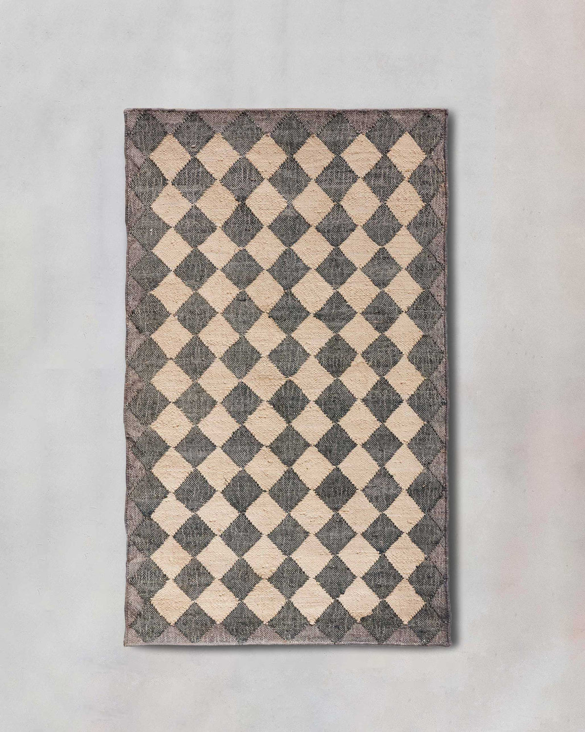 Fez Rug with a charcoal and cream diamond checkerboard pattern.