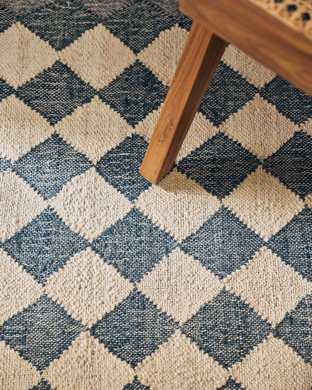 Close-up of the Fez Rug showing its blue and cream diamond weave.