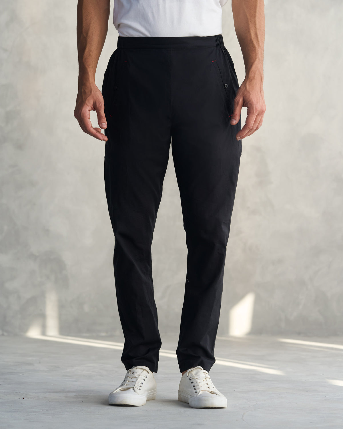 Person wearing black Kurta Pants with a tapered leg.