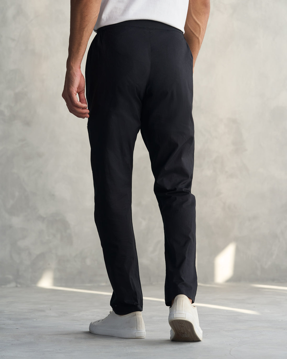 Back of black Kurta Pants worn by a person.
