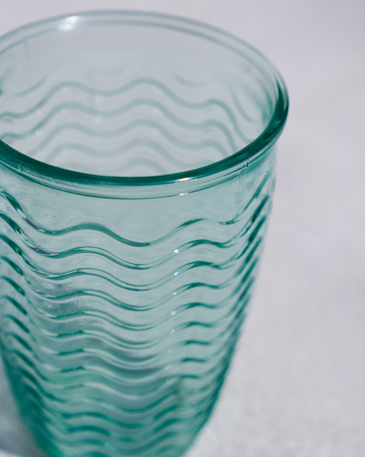 Close-up of an Aqua tumbler rim showing the wavy glass pattern.
