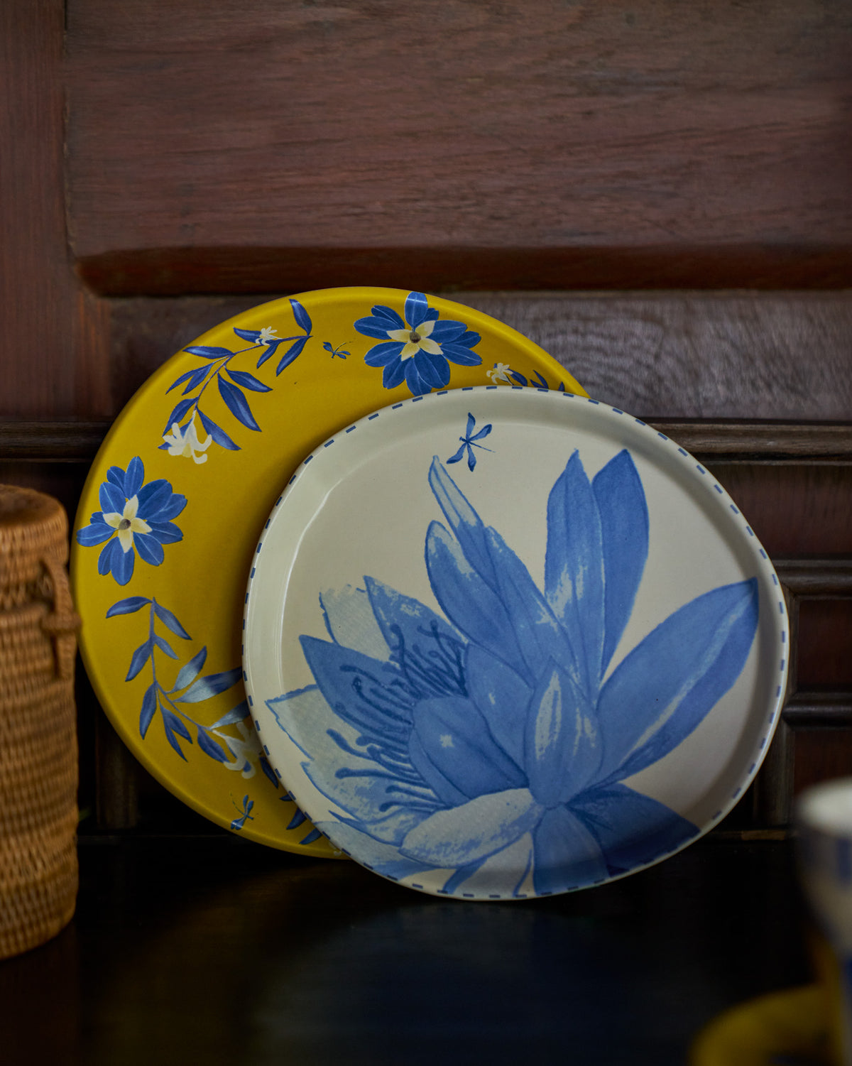 Seroja Dessert Plate in front of a yellow plate with blue flowers.