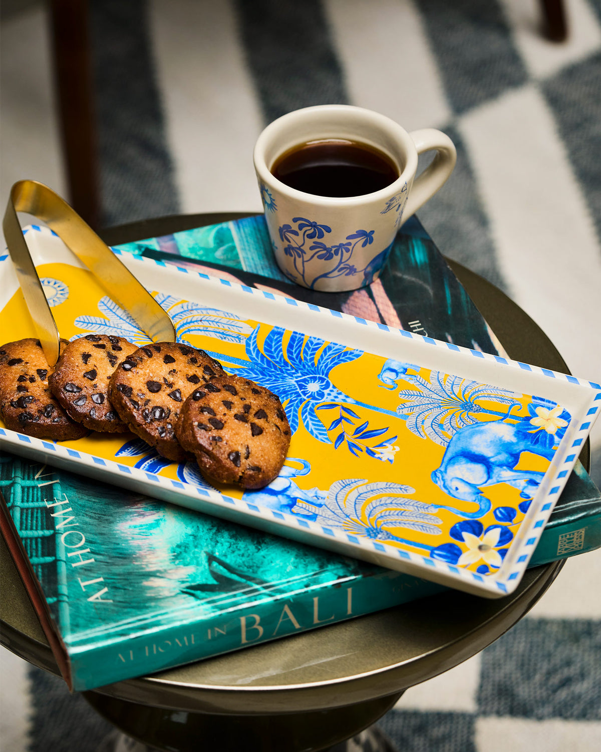 Alam Cookie Tray with Tong holding cookies beside a gold tong.