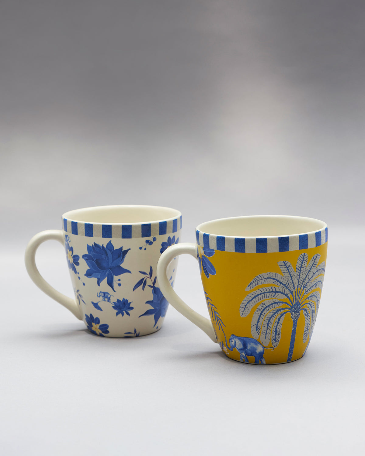 Pair of Panas conical mugs with blue elephant, palm, and floral motifs.