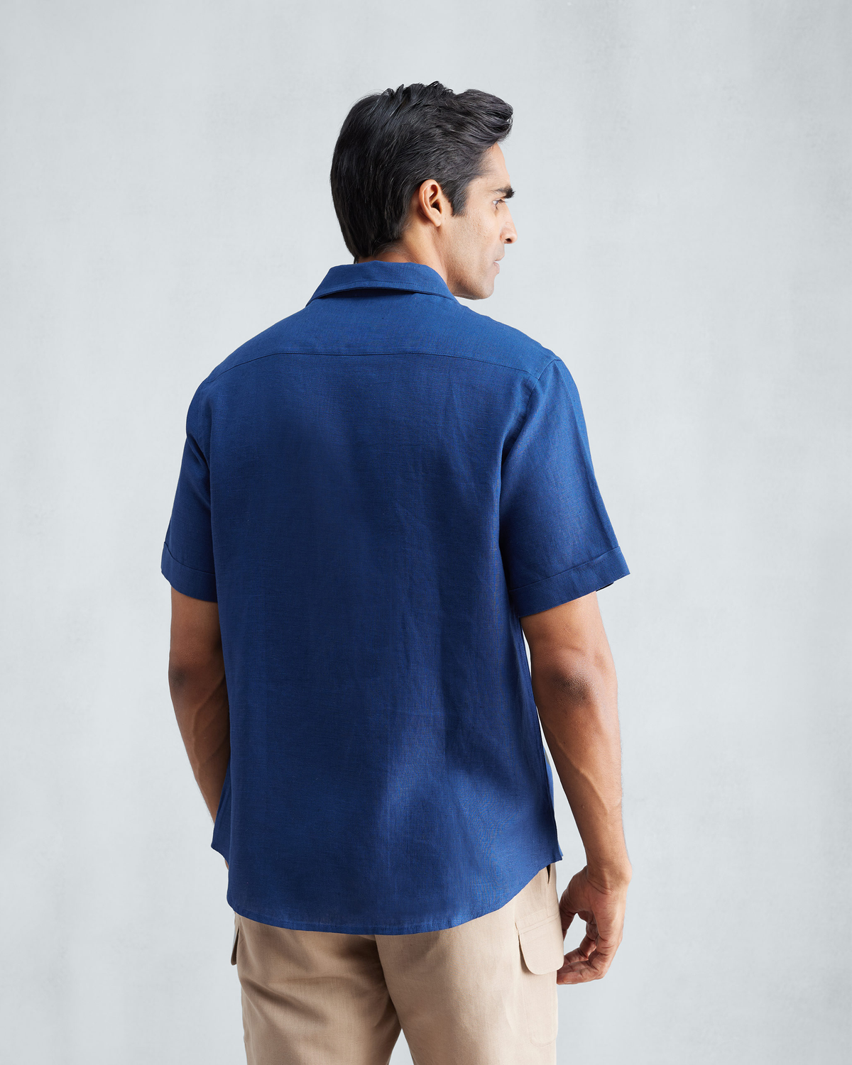 Back of a navy Half Sleeve Shirt showing a yoke and short sleeves.