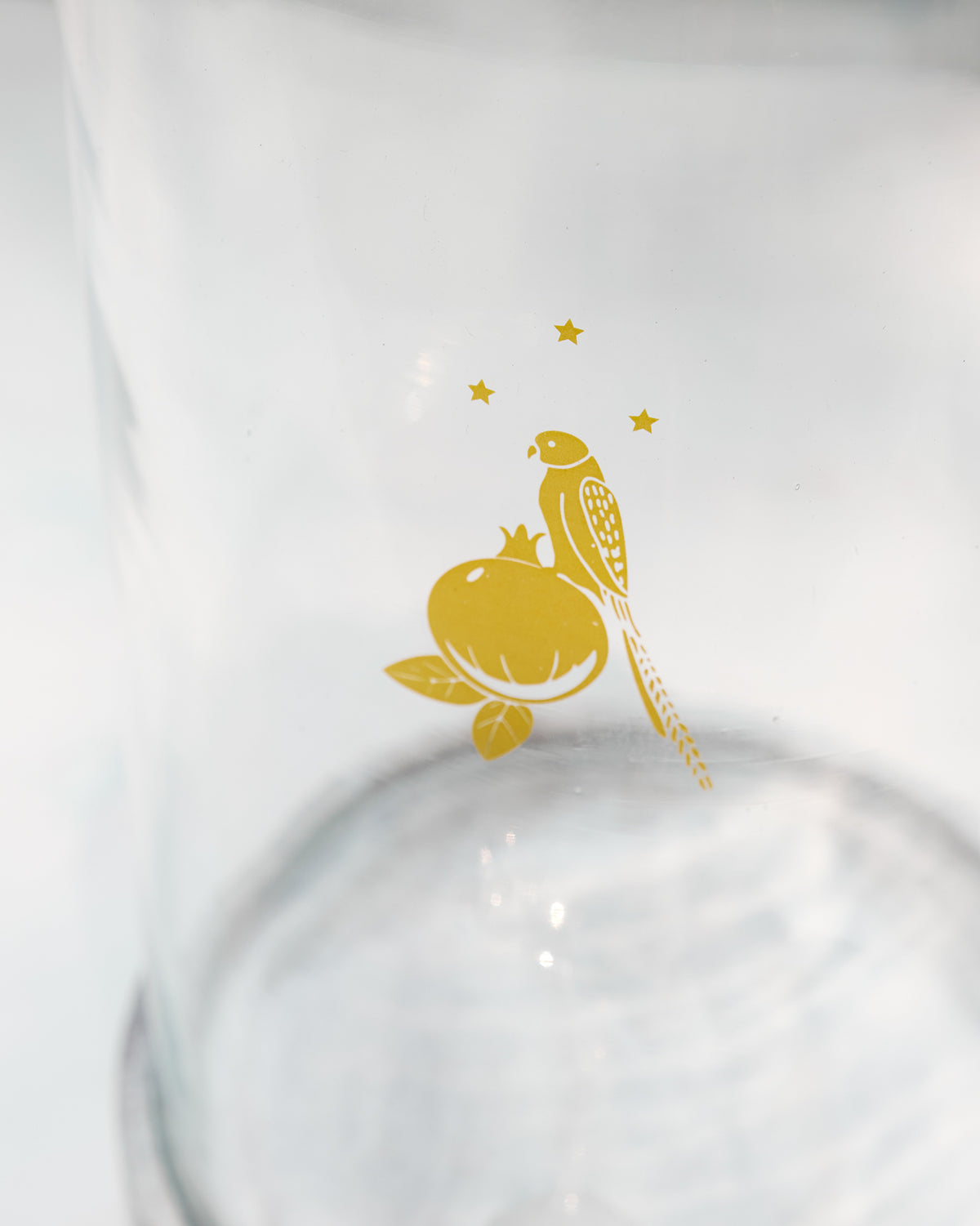 Close-up of the gold bird and pomegranate motif on a Mistle dispenser.