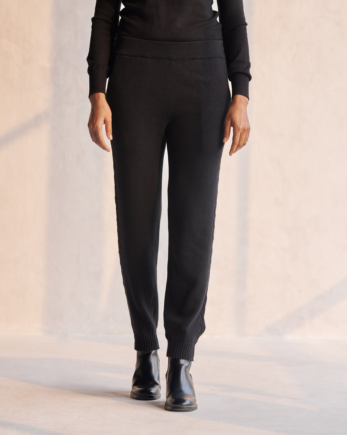 Person wearing black Pull-on Pants with ribbed ankle cuffs.