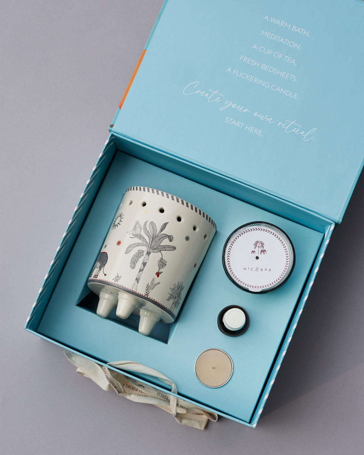 Azure gift set open in its box, with a ceramic burner and tea lights.