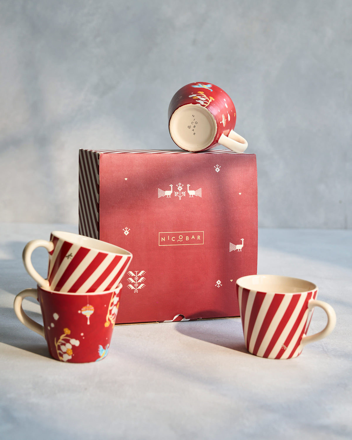 Phoenix espresso mug set of four with red stripes, bird print, and gift box.