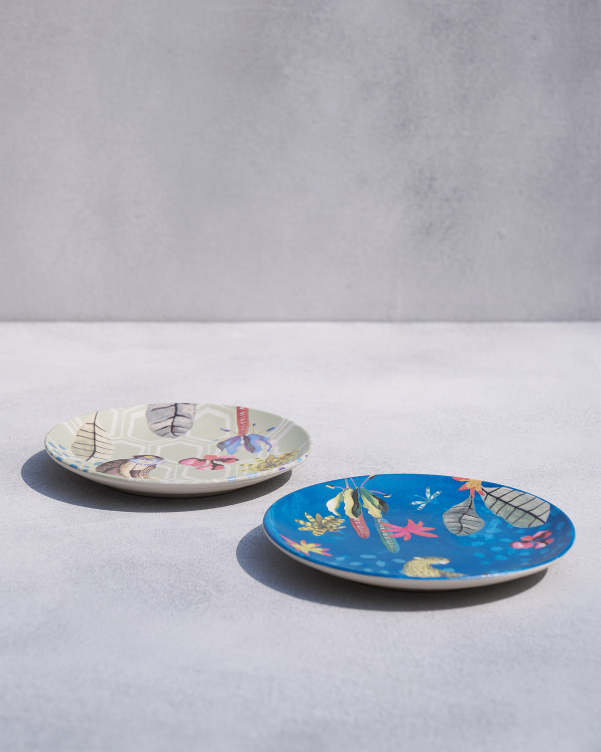 Mahi quarter plates in sage and teal with tropical animal prints.