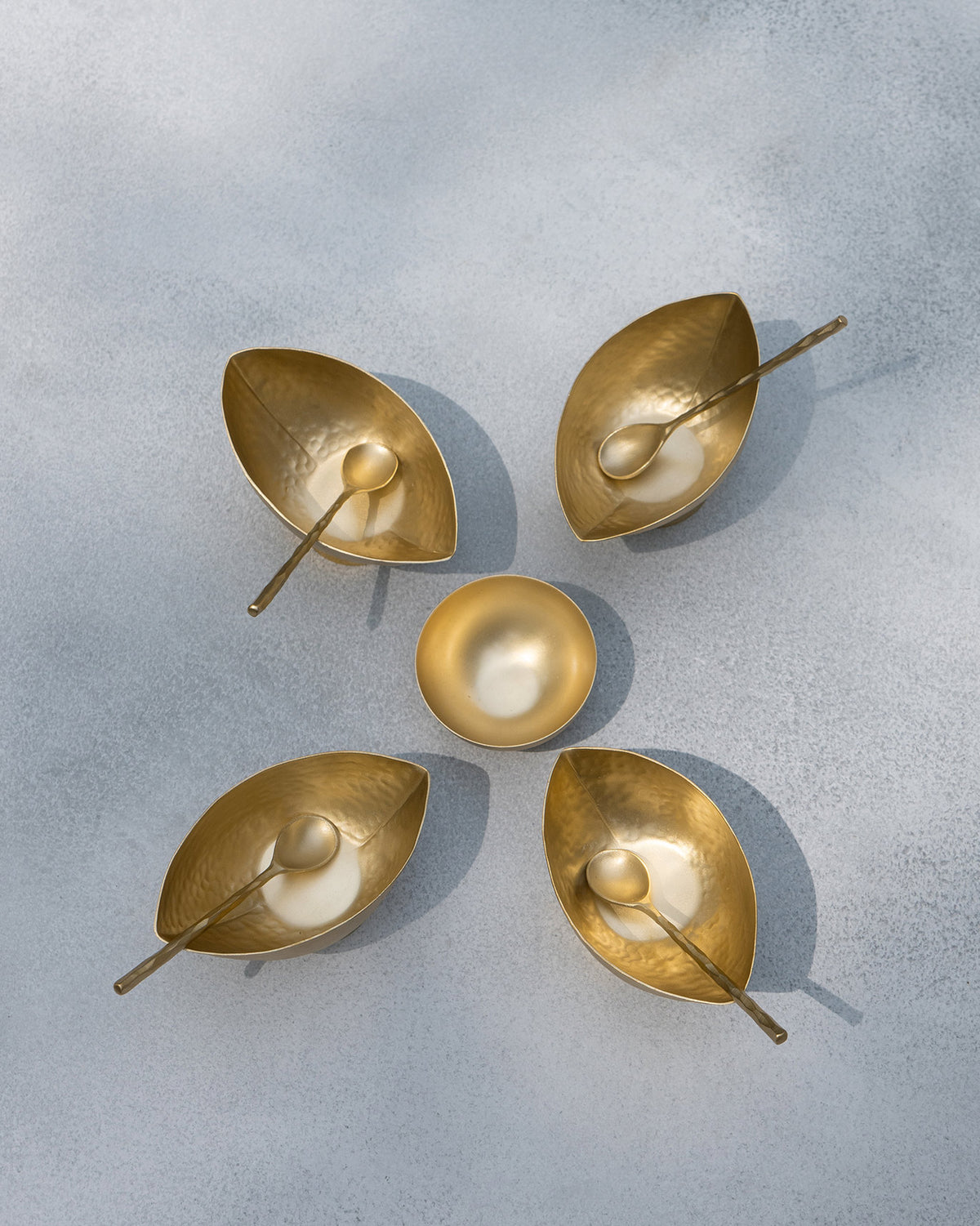 Overhead view of Chakra Gelato Cups with spoons around a small brass bowl.