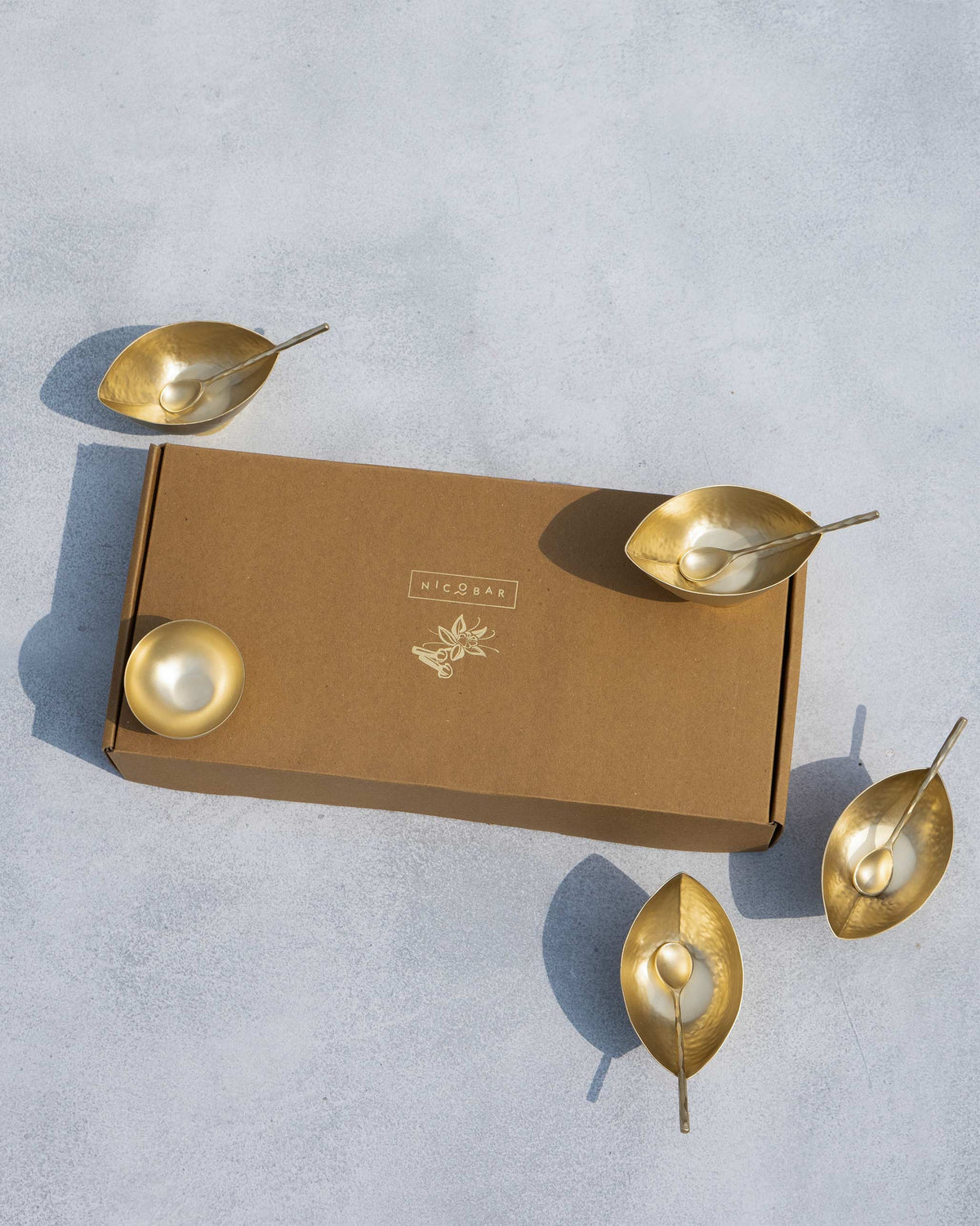 Chakra Gelato Cups and spoons arranged around a Nicobar gift box.