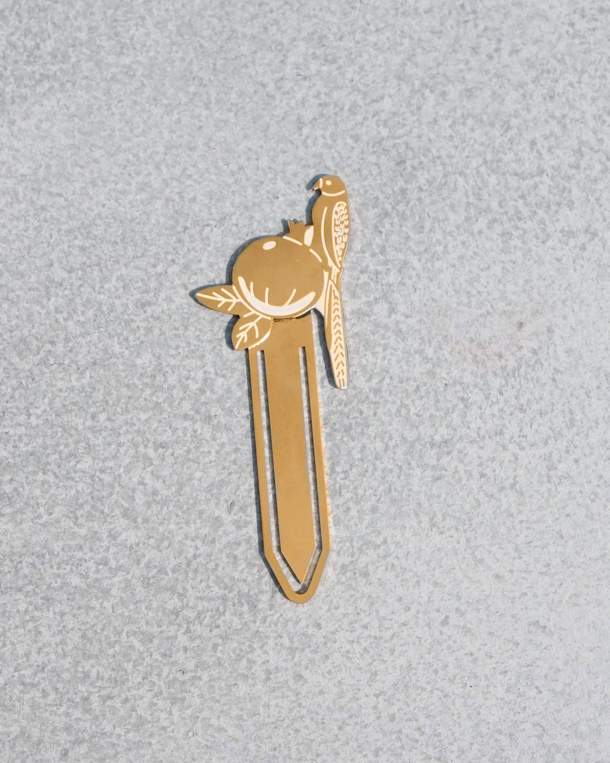 Gold Safari Tota Bookmark with a parrot perched on a pomegranate.