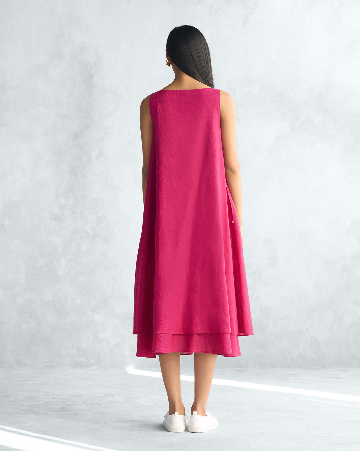Back of a sleeveless pink Double layer dress worn by a person.