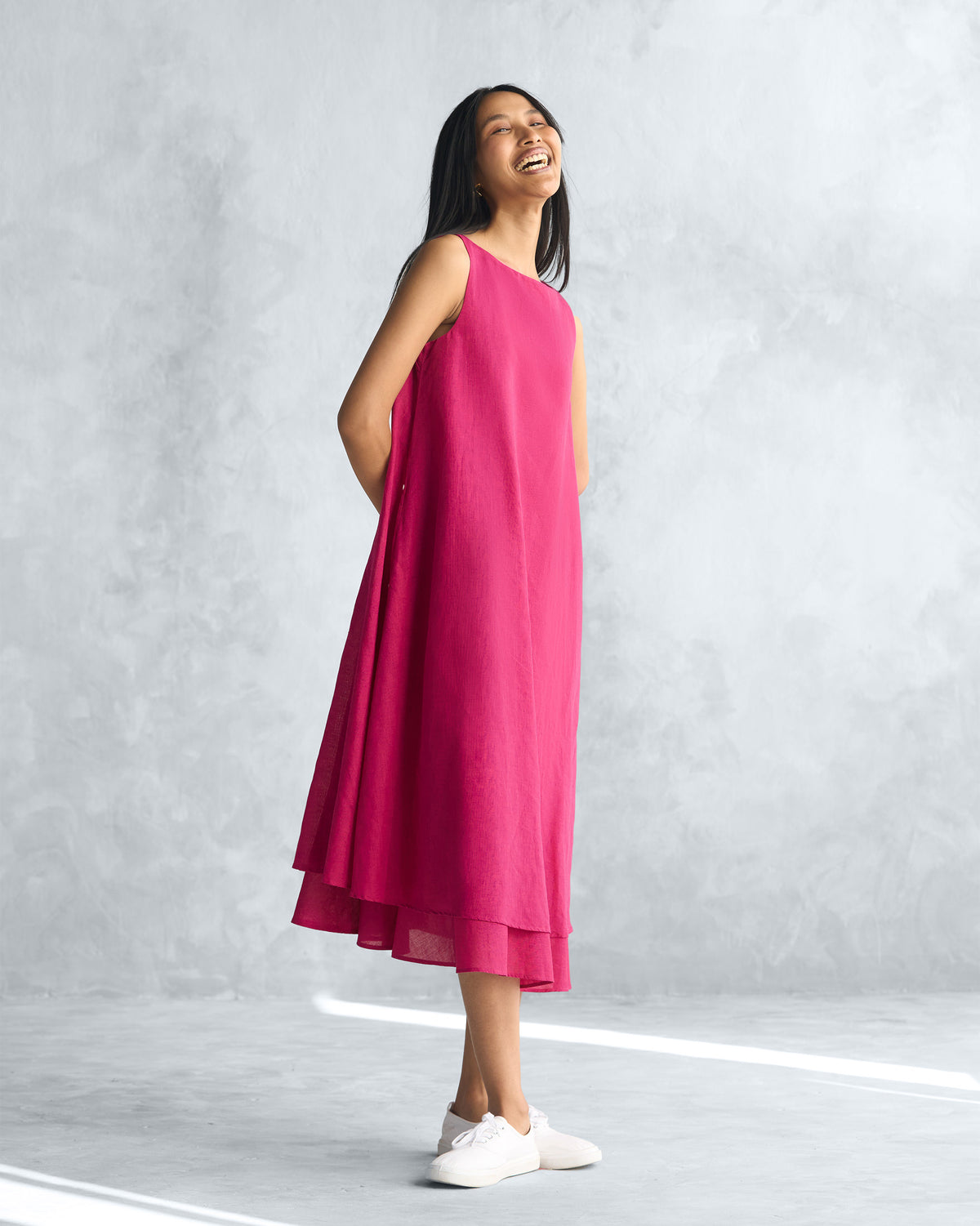 Side view of a pink Double layer dress with a layered hem.