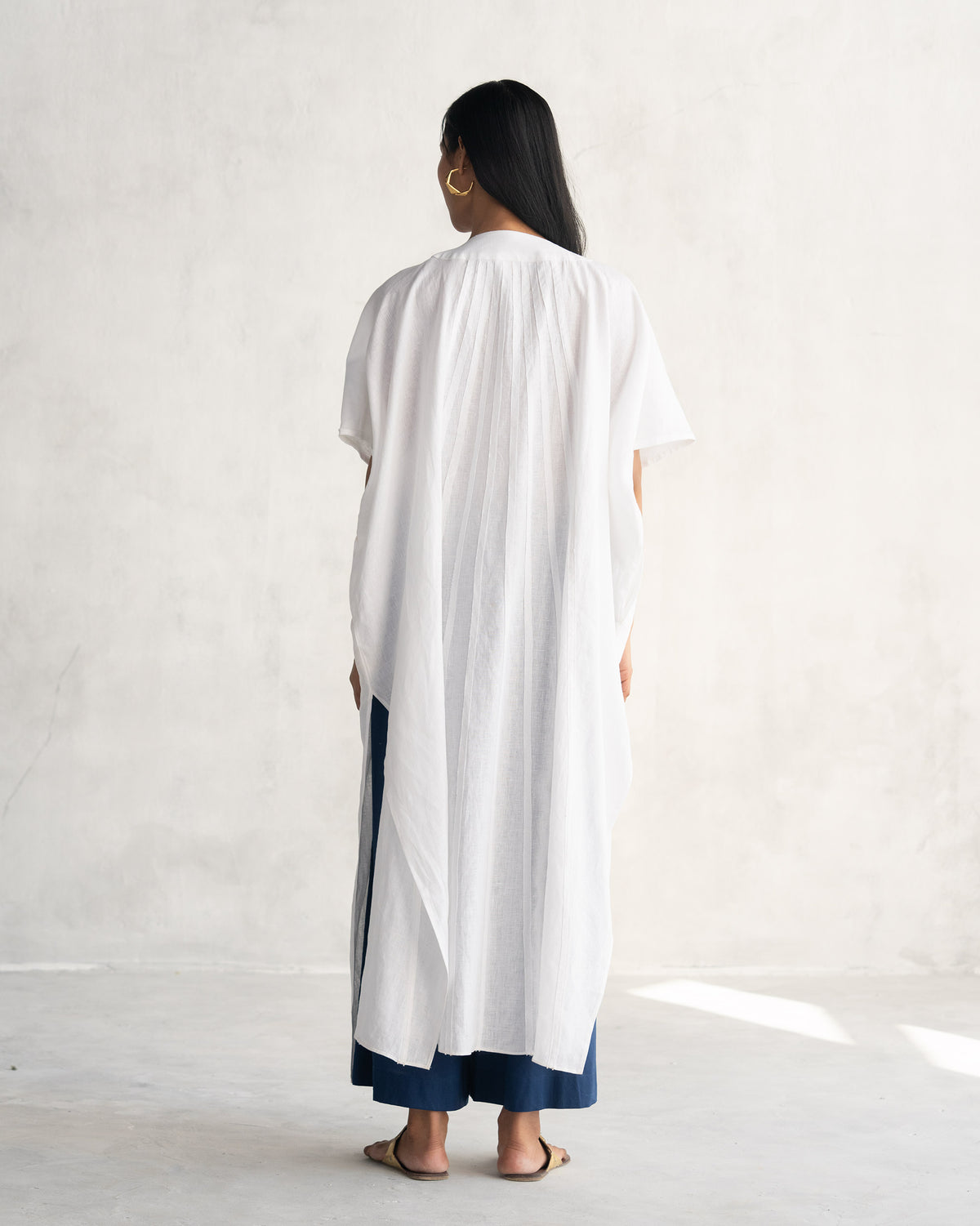 Back of a white Tulum kaftan with a gathered yoke.