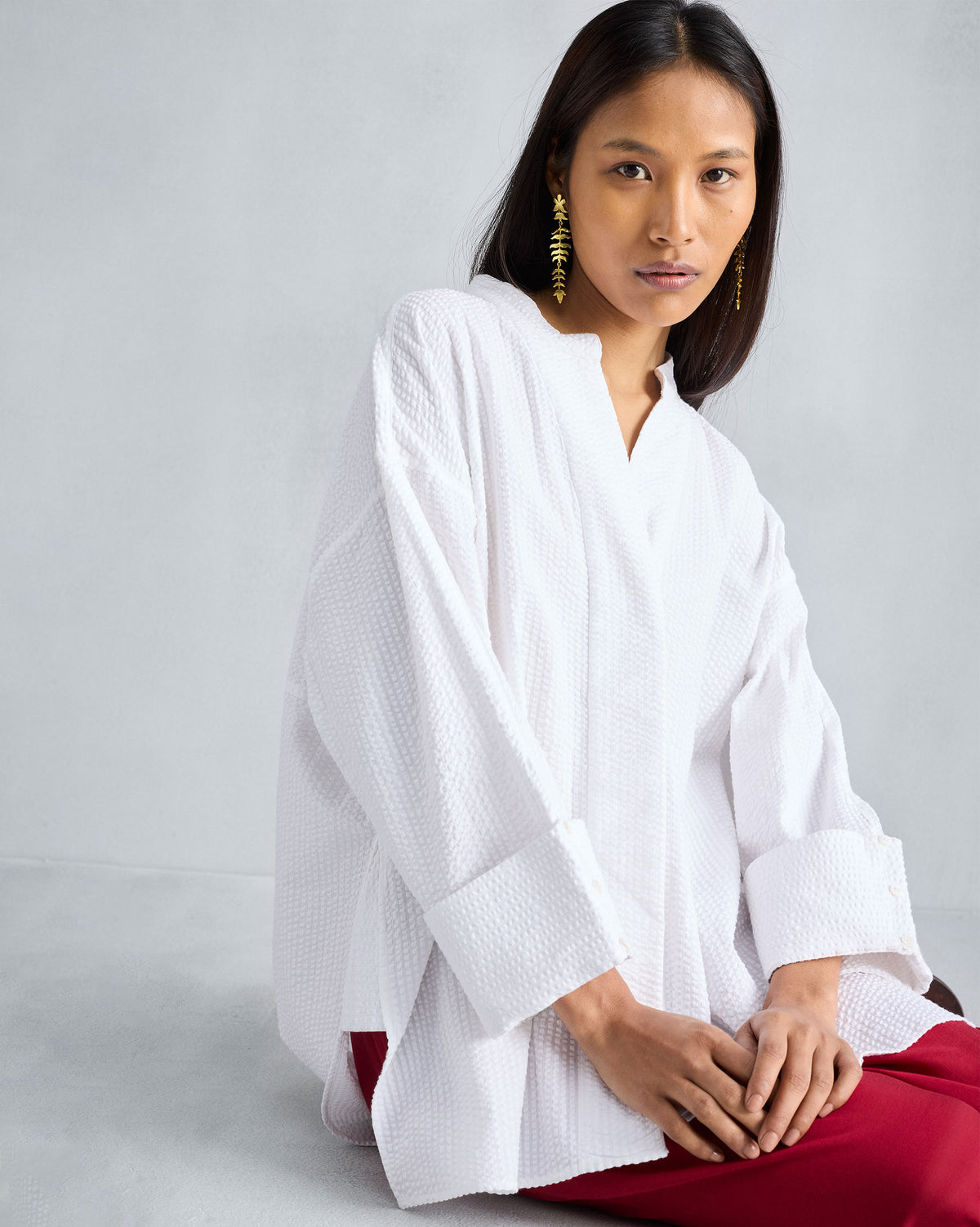 Person wearing a white Cirrus seersucker shirt with wide cuffs.