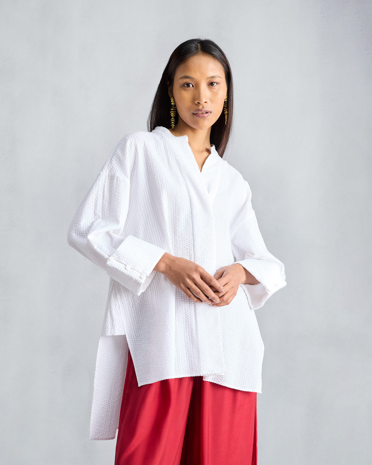 Person wearing a white Cirrus seersucker shirt with a band collar.