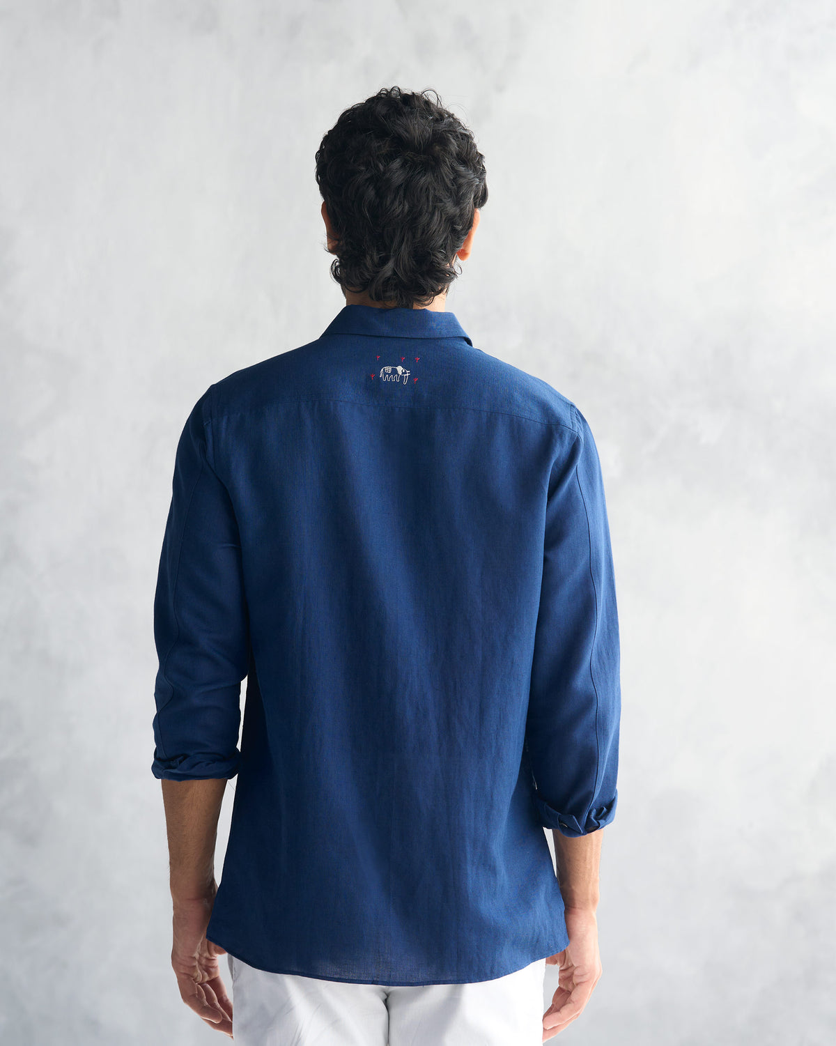 Back of a navy August Shirt with elephant embroidery at the yoke.