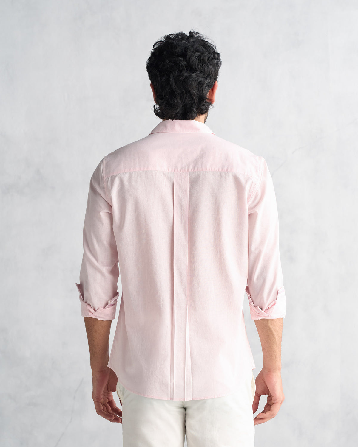 Back of a pink Classic Shirt showing the yoke and center box pleat.