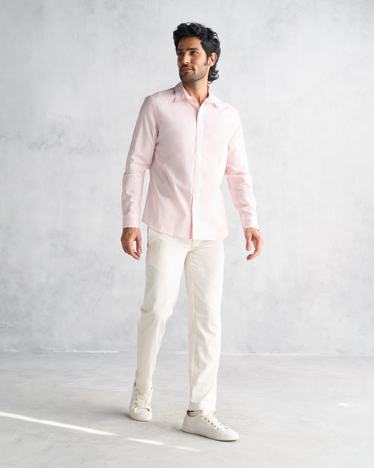 Person wearing a pink Classic Shirt untucked at full length.