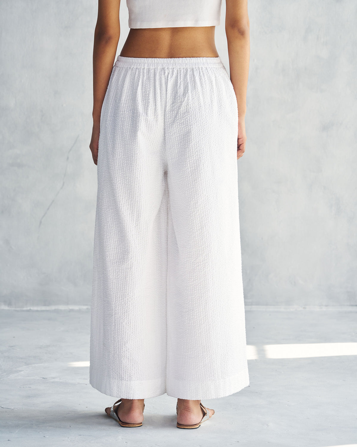 Back of white seersucker Basic Pyjamas with a gathered elastic waist.