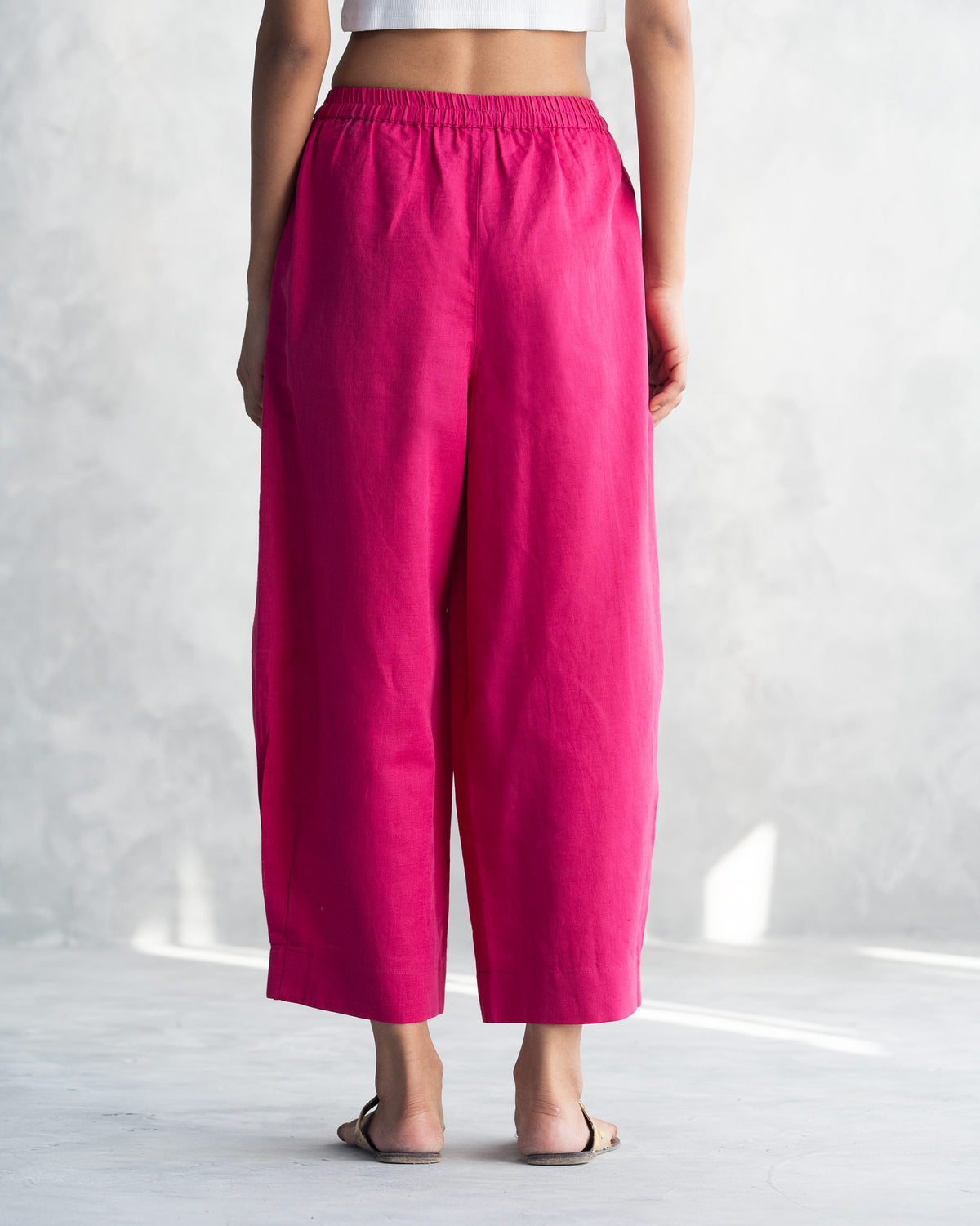 Back of berry Serene pants worn by a person.