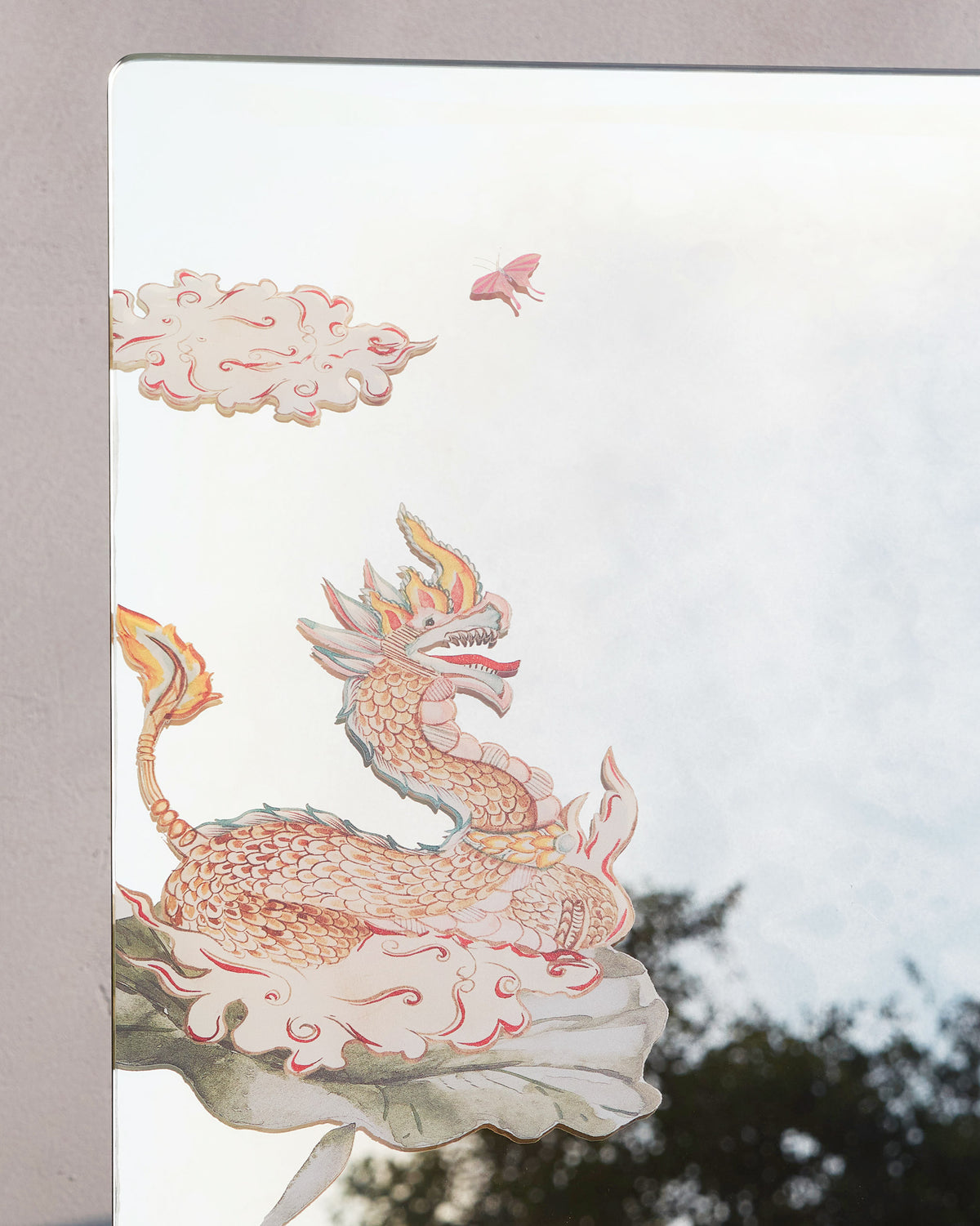 Close-up of the Lotus Mirror showing a dragon, clouds and a lotus leaf.
