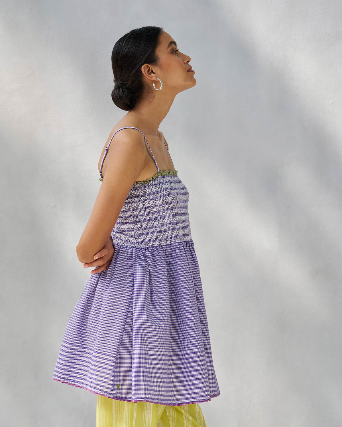 Side view of a purple and white Paradise top showing the smocked bodice and flared hem.