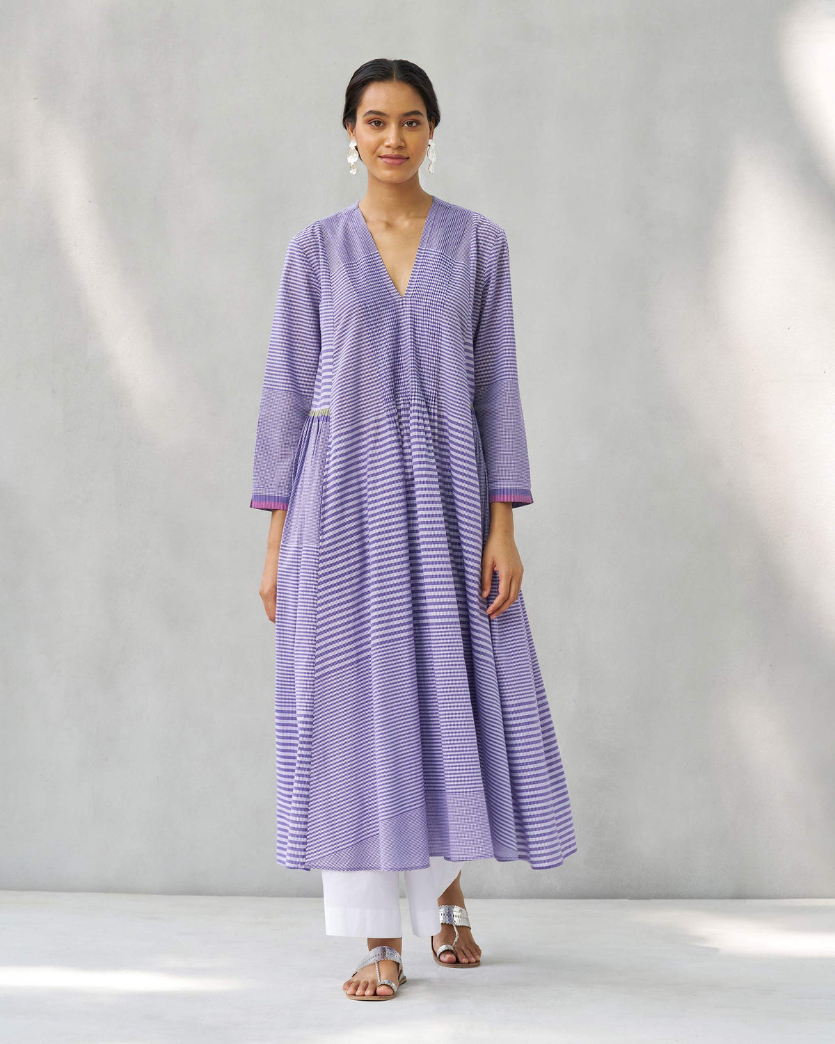 Person wearing a purple and white Pintuck kurta with multi-directional stripes.