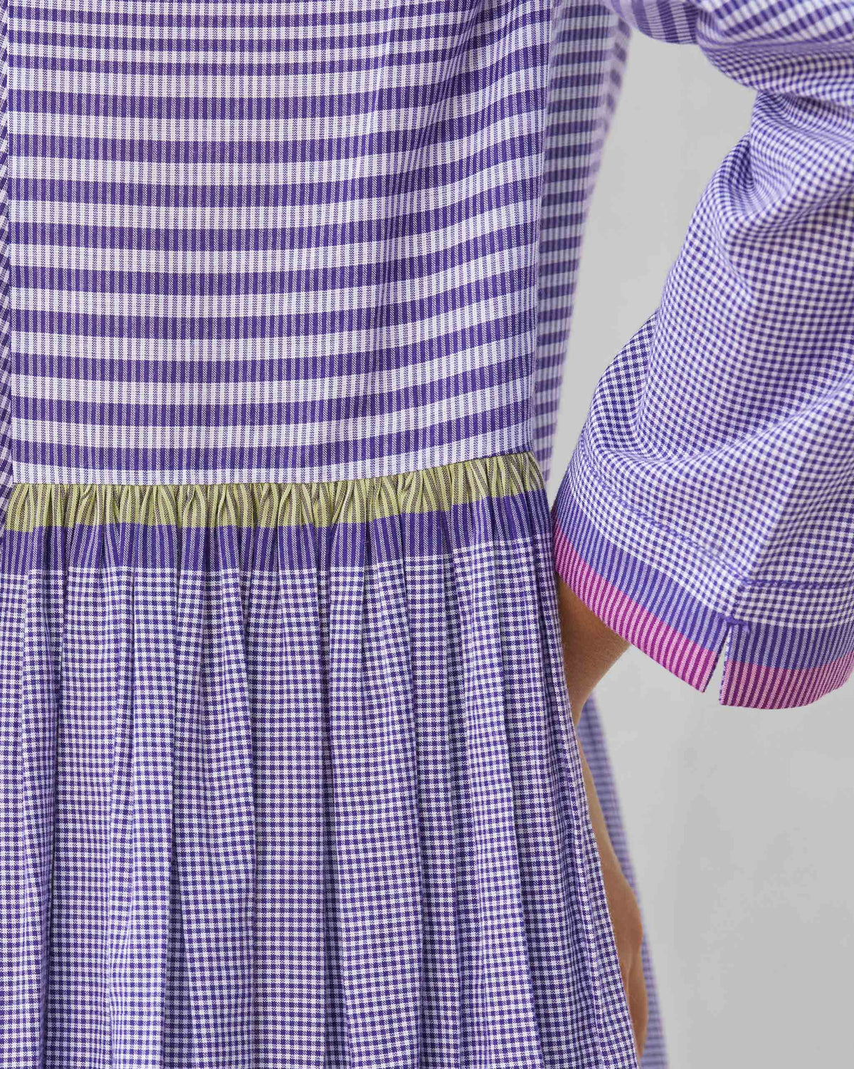 Close-up of the gathered waist and striped cuff on a purple and white Pintuck kurta.