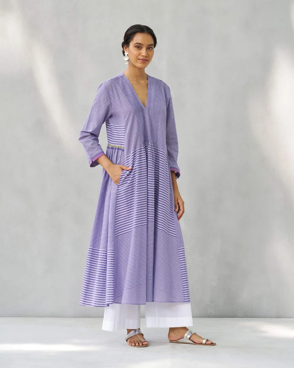 Person wearing a purple and white Pintuck kurta with a flared A-line silhouette.
