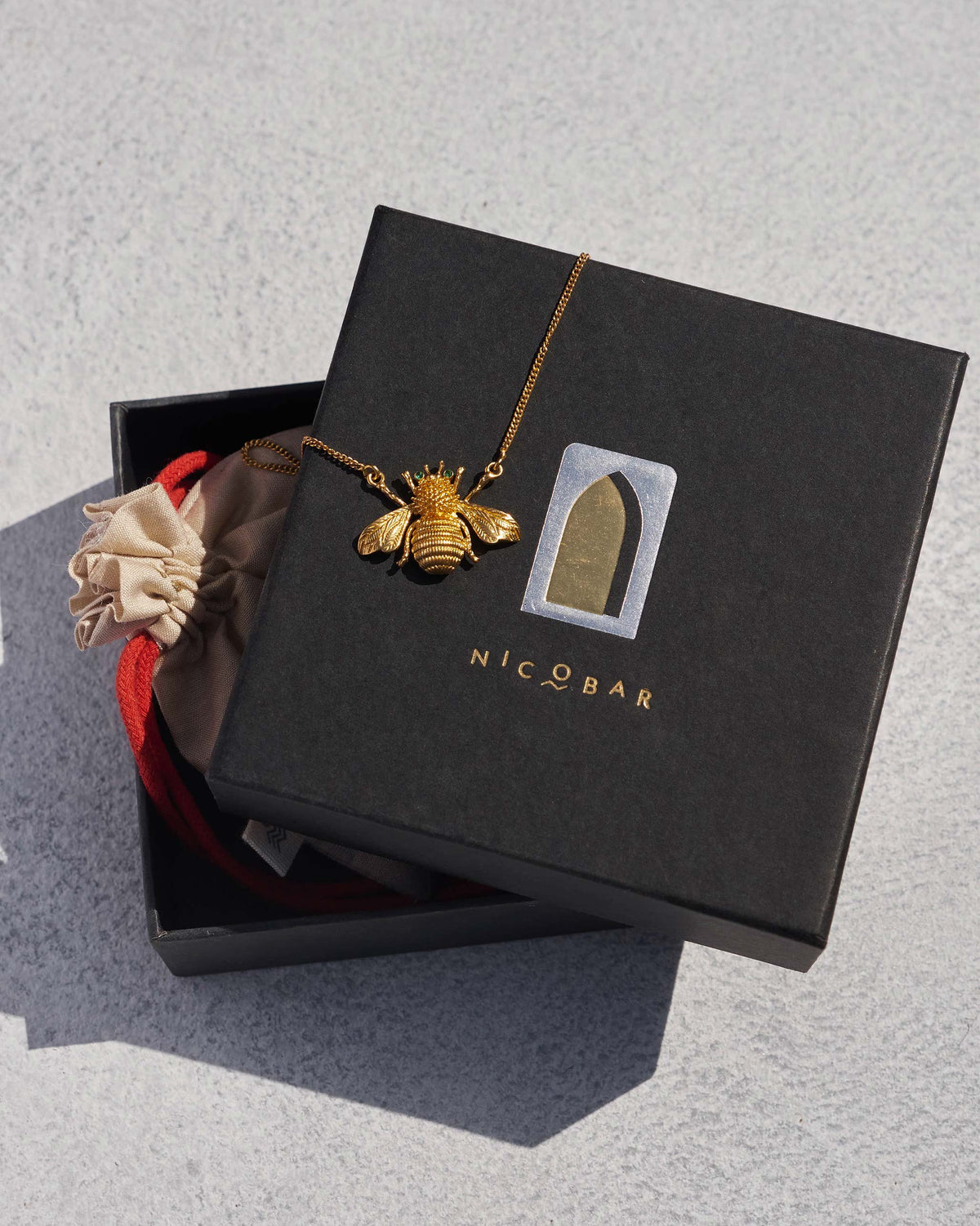 Bee Necklace with a gold bee pendant, shown in its black gift box.