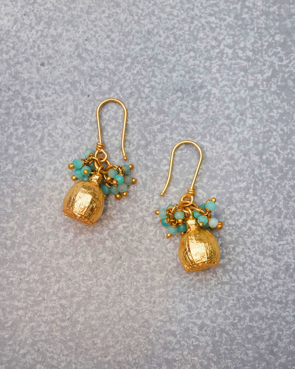 Pair of Himalayan Poppy Drops Earrings laid flat on a grey surface.