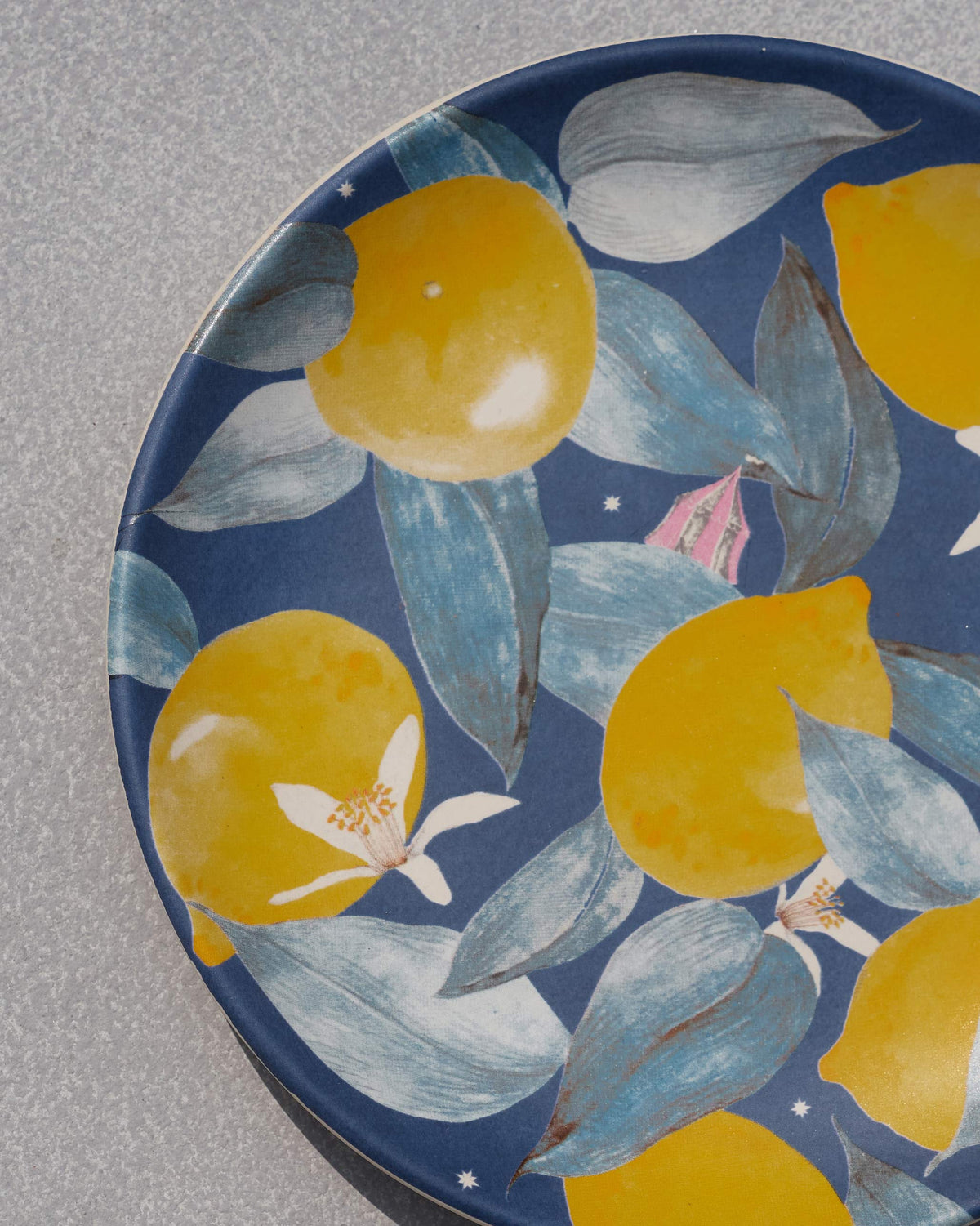 Close-up of Asfar quarter plate showing lemons, leaves and white blossoms.