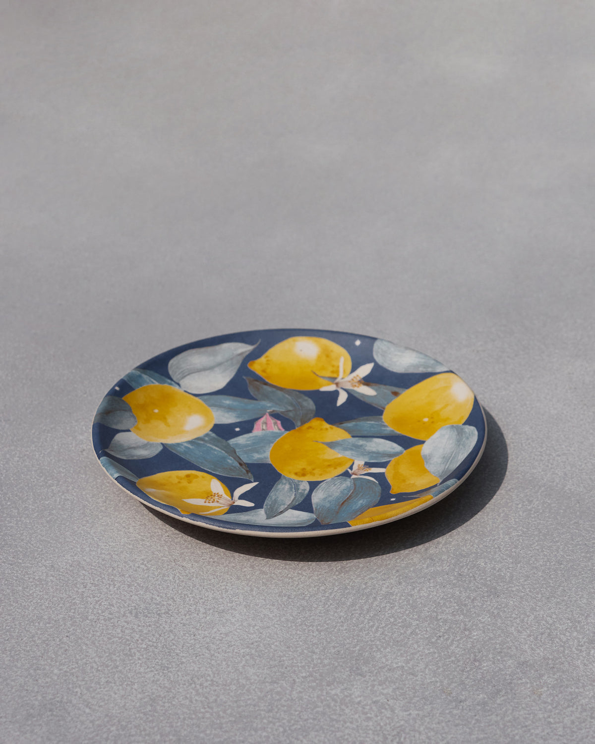 Side view of Asfar quarter plate with lemon and leaf print.